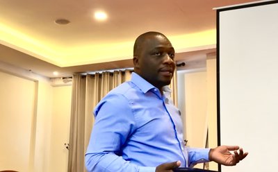 Michael Kamukulu speaking at a conference